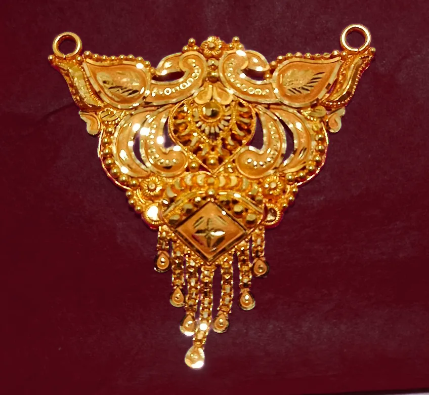 Gold filigree pendant with peacock motifs and tassels