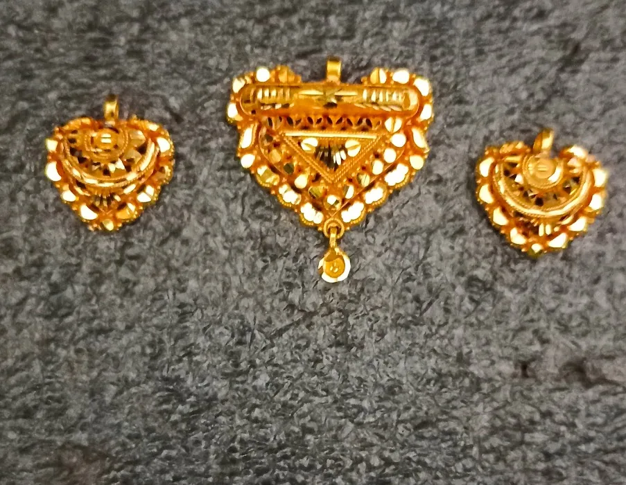 Matching gold heart-shaped pendant and earrings