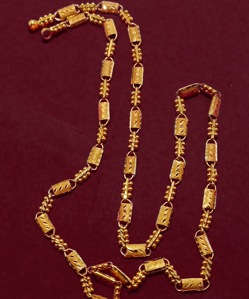 Long gold chain with engraved barrel links