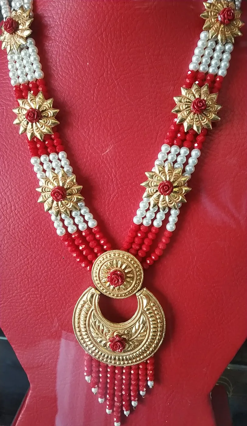 Long rani haar necklace of red and white beads with gold crescent pendant